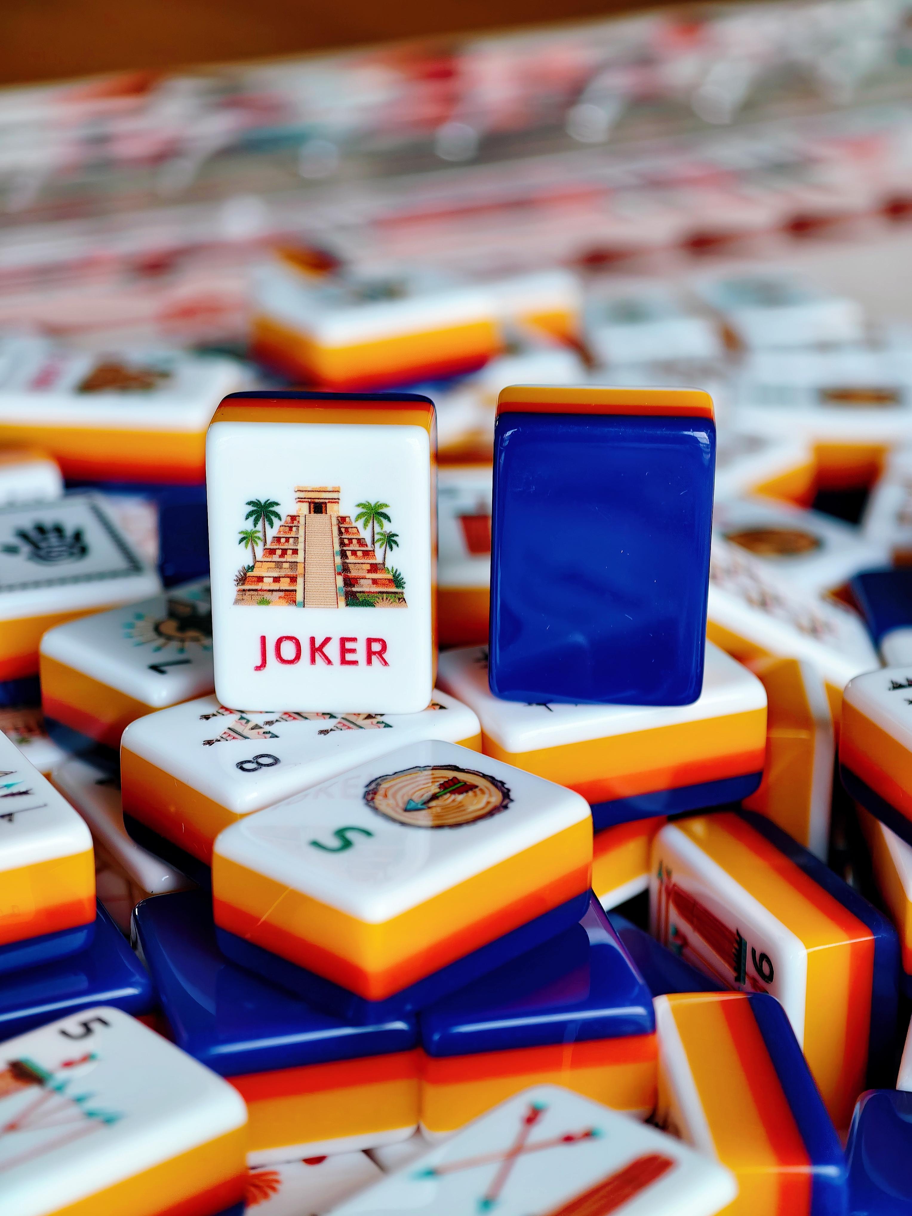 Pink-backed Mahjong tiles held in a hand